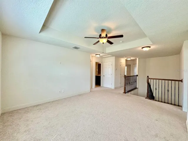 a view of room with a ceiling fan and window