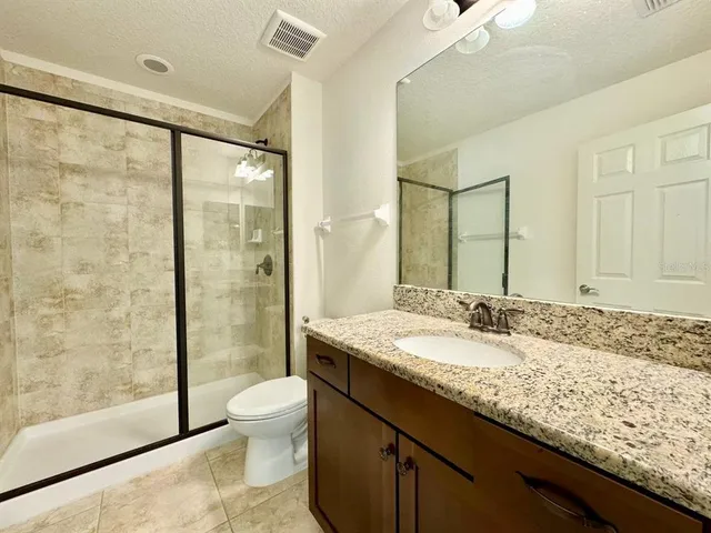 an empty room with window and ceiling fan