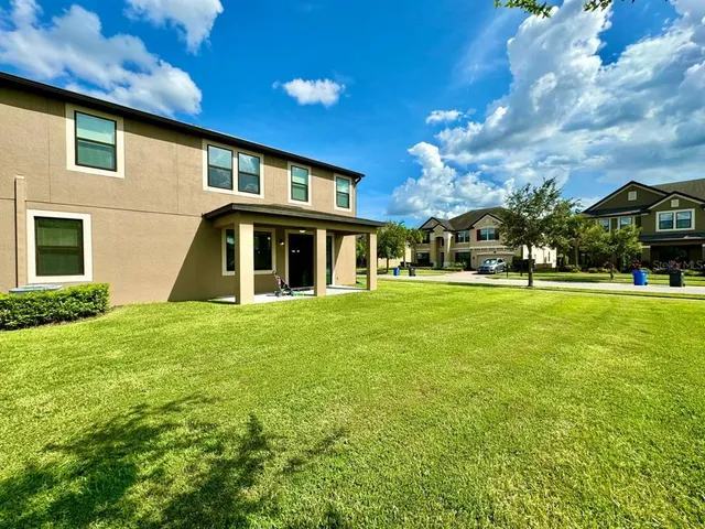 an aerial view of a house with a yard