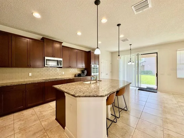 a kitchen with a sink stove and microwave