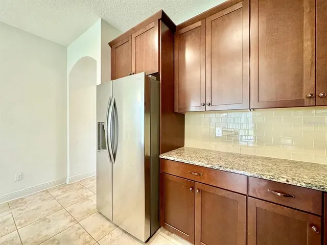 a large kitchen with granite countertop stainless steel appliances and a sink