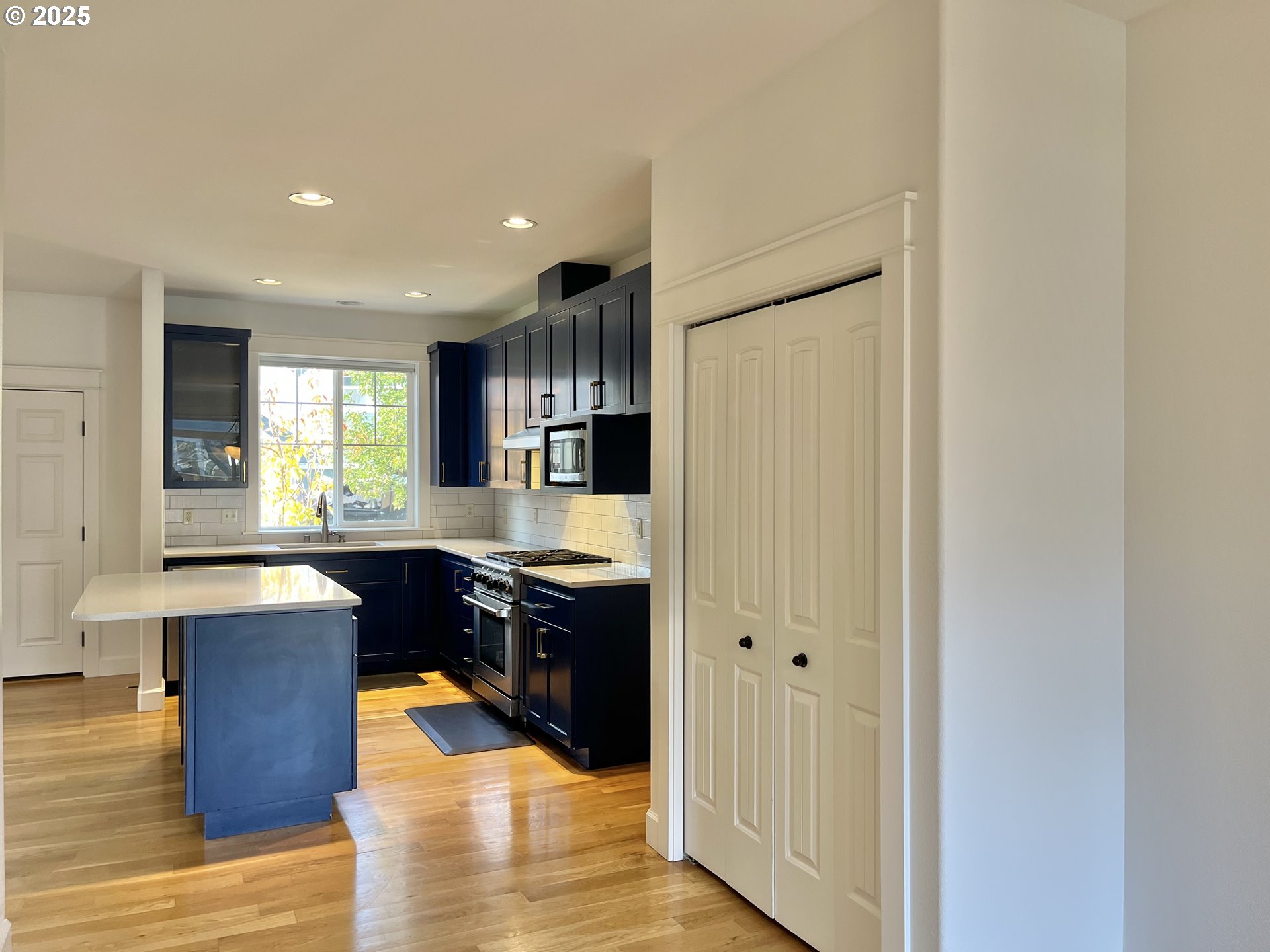 3535 Southeast 197th Avenue Camas, WA 98607 - Photo 7 of 24 a kitchen with stainless steel appliances granite countertop a refrigerator a sink dishwasher and wooden cabinets with wooden floor