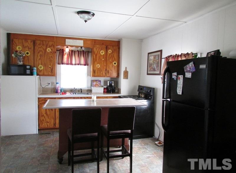 212 Cavel Chub Lake Road Roxboro, NC 27574 - Photo 4 of 18 Fresh country kitchen has movable bar.