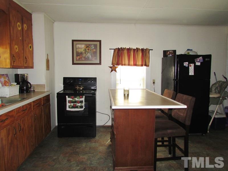212 Cavel Chub Lake Road Roxboro, NC 27574 - Photo 5 of 18 Custom built cabinets, new counter tops, enclosed water heater, kitchen appliances convey too