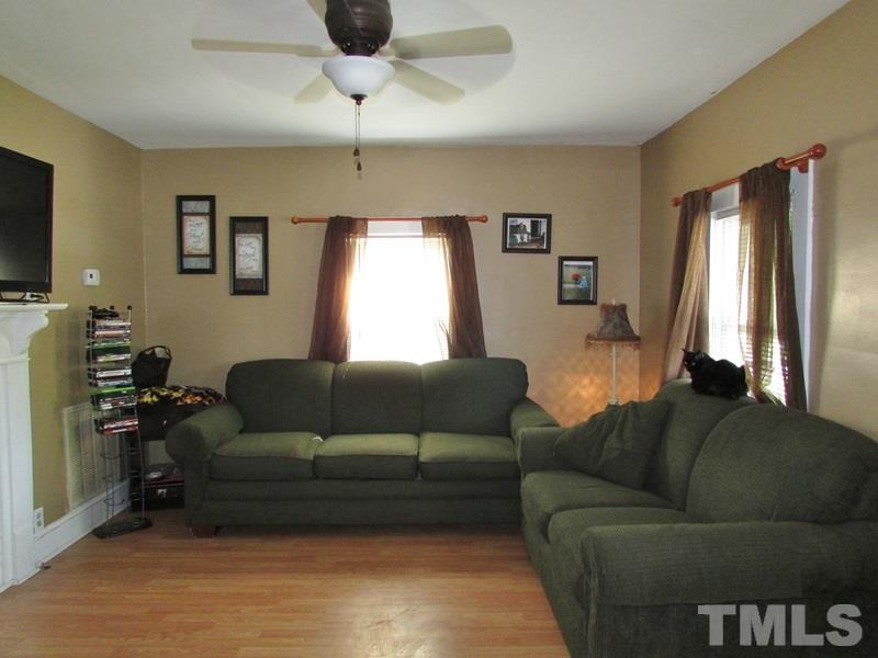212 Cavel Chub Lake Road Roxboro, NC 27574 - Photo 8 of 18 Cozy living area with new laminate flooring, ceiling fan, and plenty of natural light