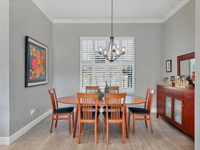 a view of a dining room with furniture wooden floor and chandelier