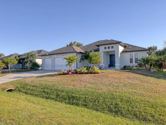 a front view of a house with yard and green space