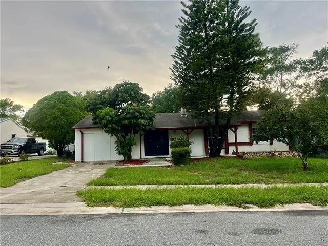a front view of house with yard and green space