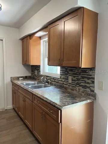 a kitchen with granite countertop a sink and a stove