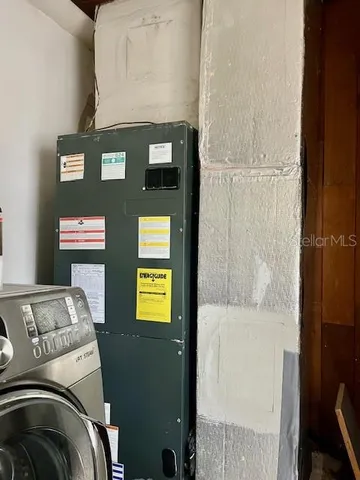 a bedroom with a bed and paintings on the wall
