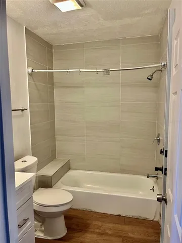 a bathroom with a toilet and a bath tub