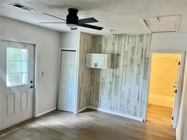 a view of a hallway with wooden floor