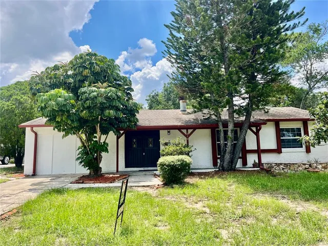 a house view with a seating space and garden