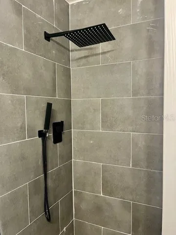a bathroom with a shower and a shower
