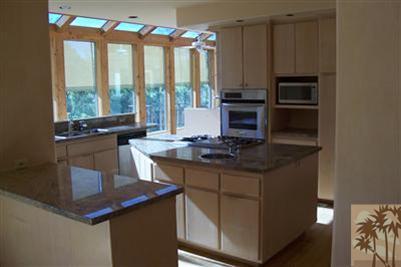 60533 Devils Ladder Road Mountain Center, CA 92561 - Photo 2 of 8 a kitchen with kitchen island granite countertop a stove and a sink