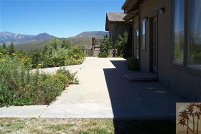 60533 Devils Ladder Road Mountain Center, CA 92561 - Photo 3 of 8 a view of a house with a yard and pathway