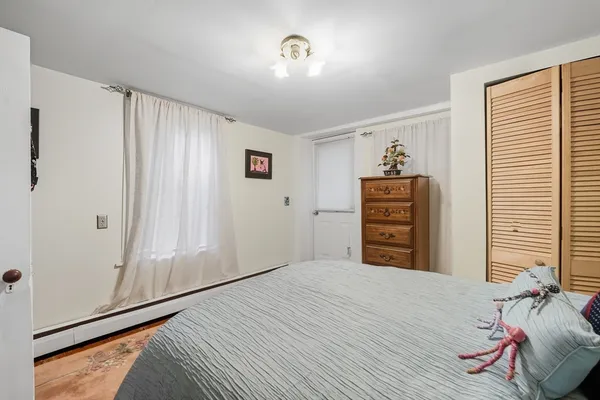 a view of a bedroom with closet and cabinet
