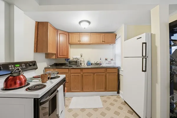 a kitchen with stainless steel appliances a stove a sink and a refrigerator