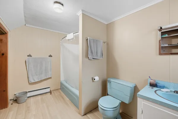 a white toilet sitting next to a bathroom sink