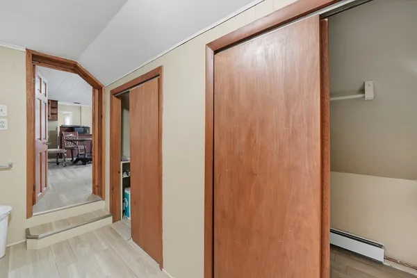 a view of a hallway with a livingroom and a bathroom