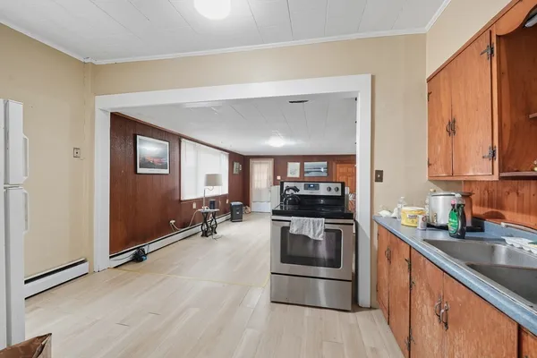 a kitchen with stainless steel appliances granite countertop a stove a sink and a refrigerator