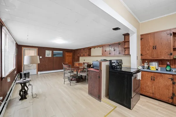 a kitchen with stainless steel appliances kitchen island granite countertop a refrigerator a stove a sink dishwasher and cabinets with wooden floor