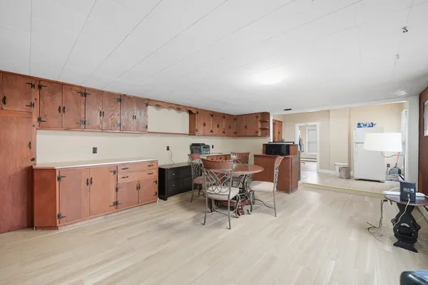 a kitchen with a table chairs and a refrigerator