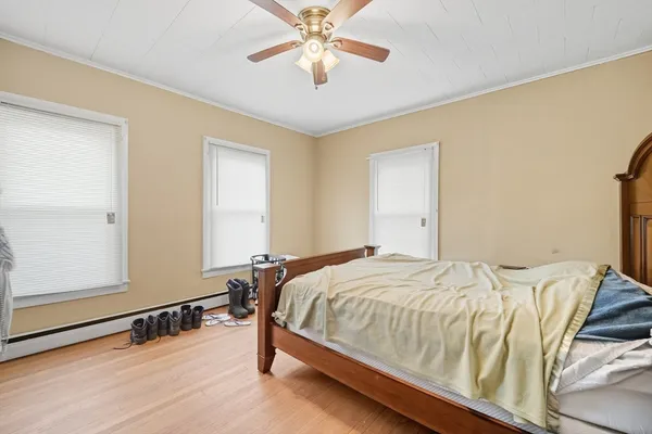 a bedroom with a bed and a chandelier