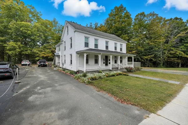 a view of a house with a garden and pathway