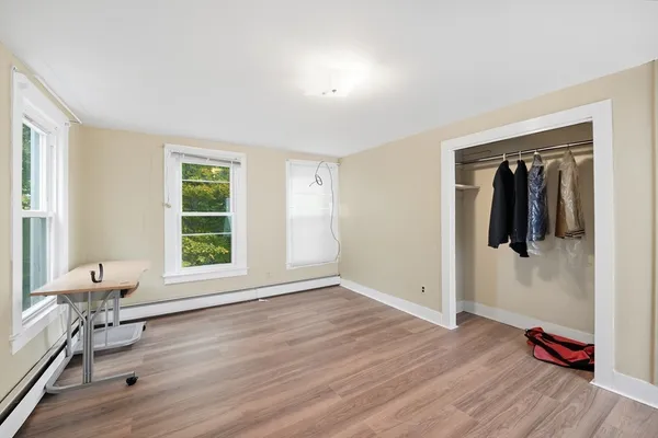 a view of a livingroom with wooden floor and a window