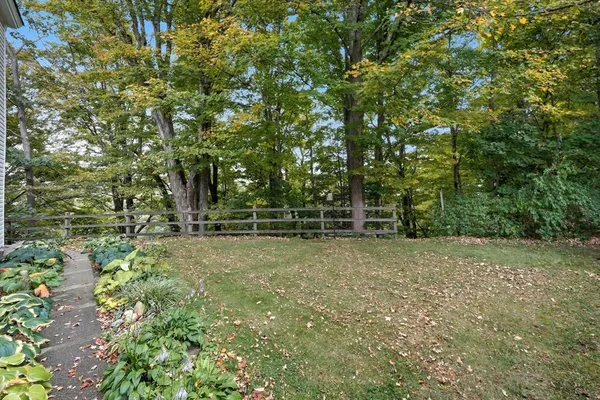 a view of a field with trees in the background