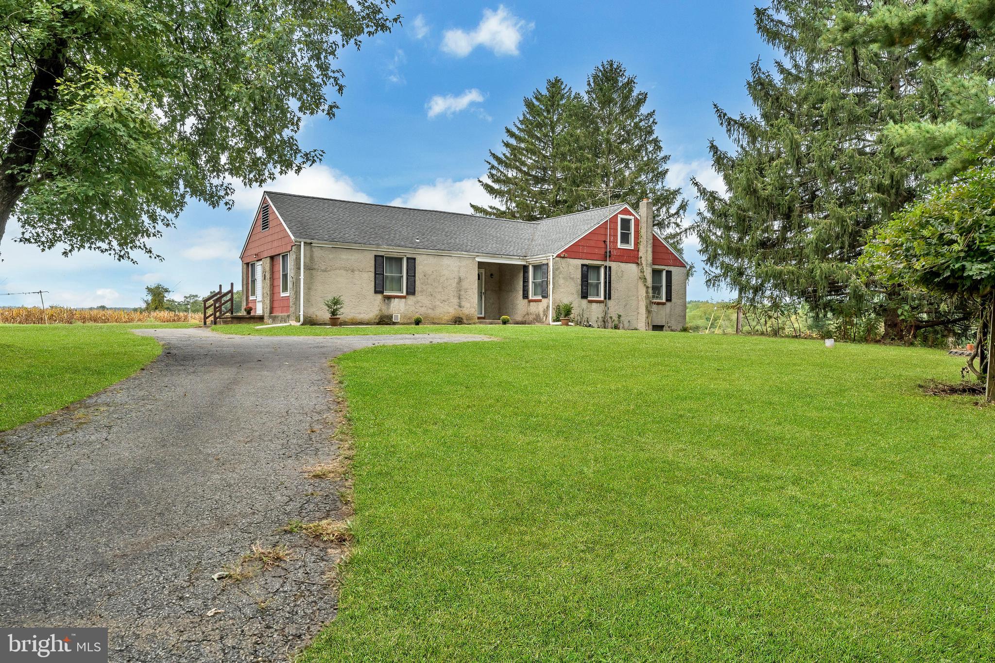 18225 Gunpowder Road Hampstead, MD 21074 - Photo 1 of 30 a front view of a house with a yard and trees