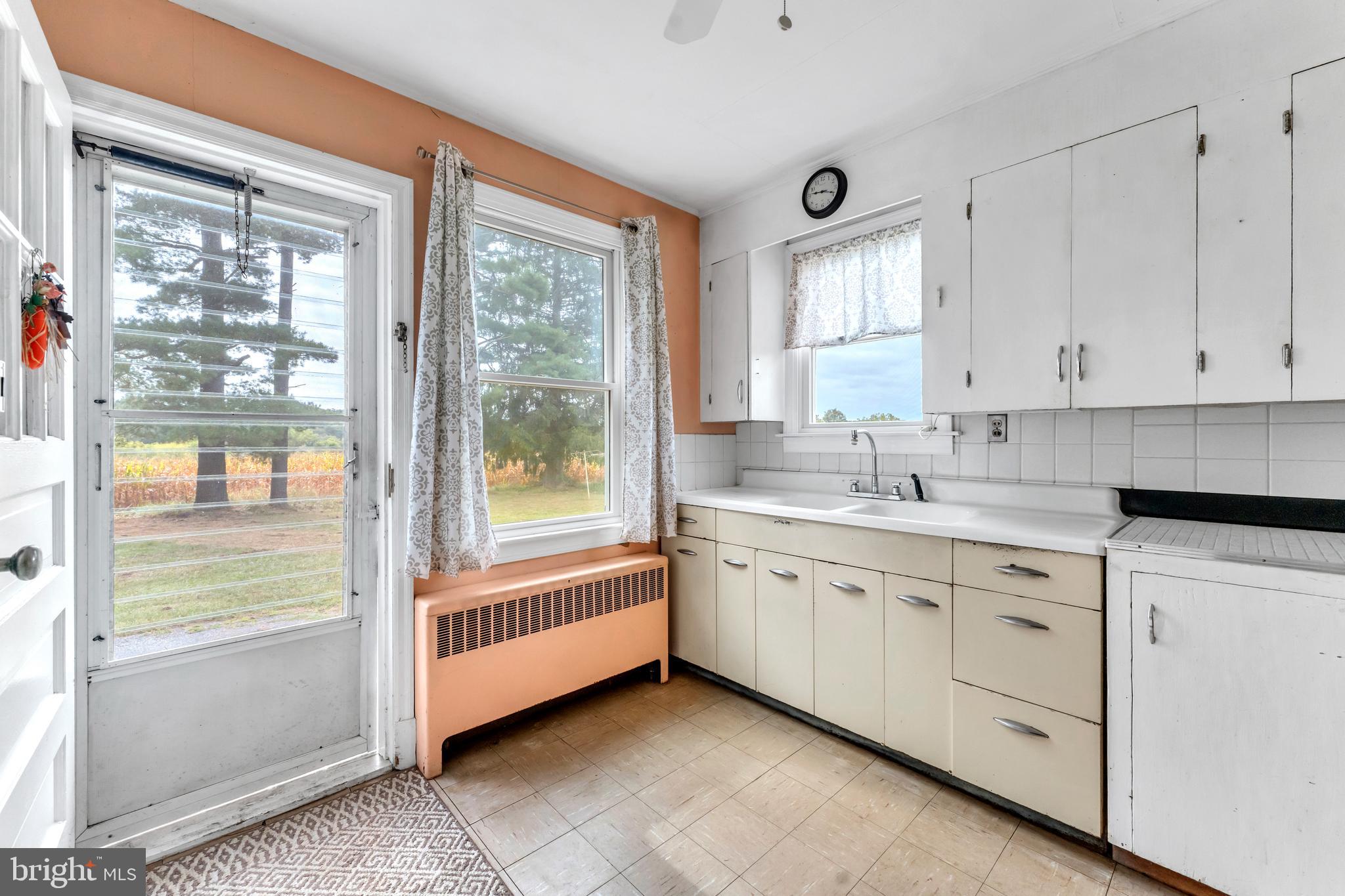 18225 Gunpowder Road Hampstead, MD 21074 - Photo 12 of 30 a large white kitchen with cabinets and a window
