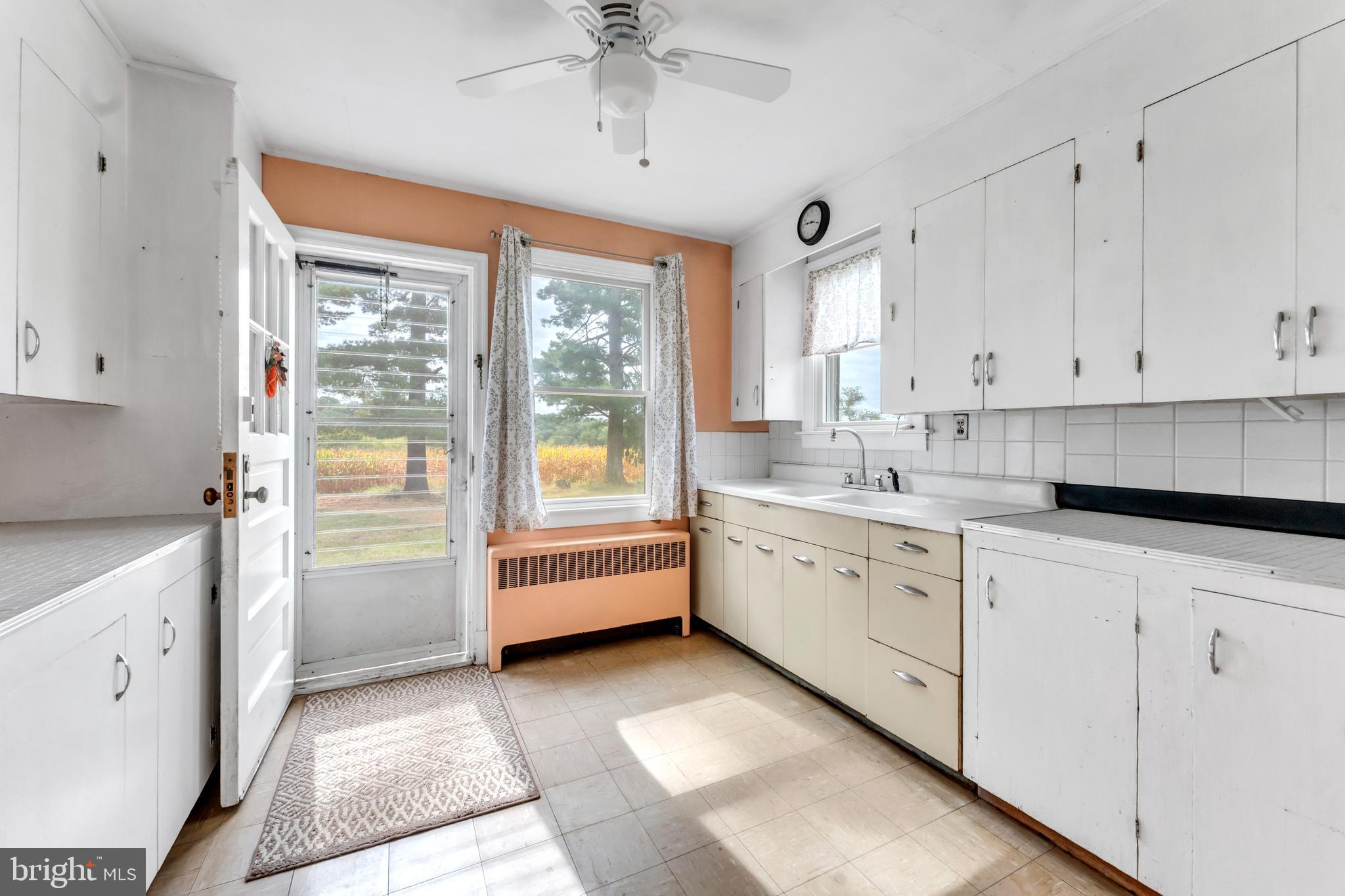 18225 Gunpowder Road Hampstead, MD 21074 - Photo 7 of 30 a kitchen with white cabinets and white appliances
