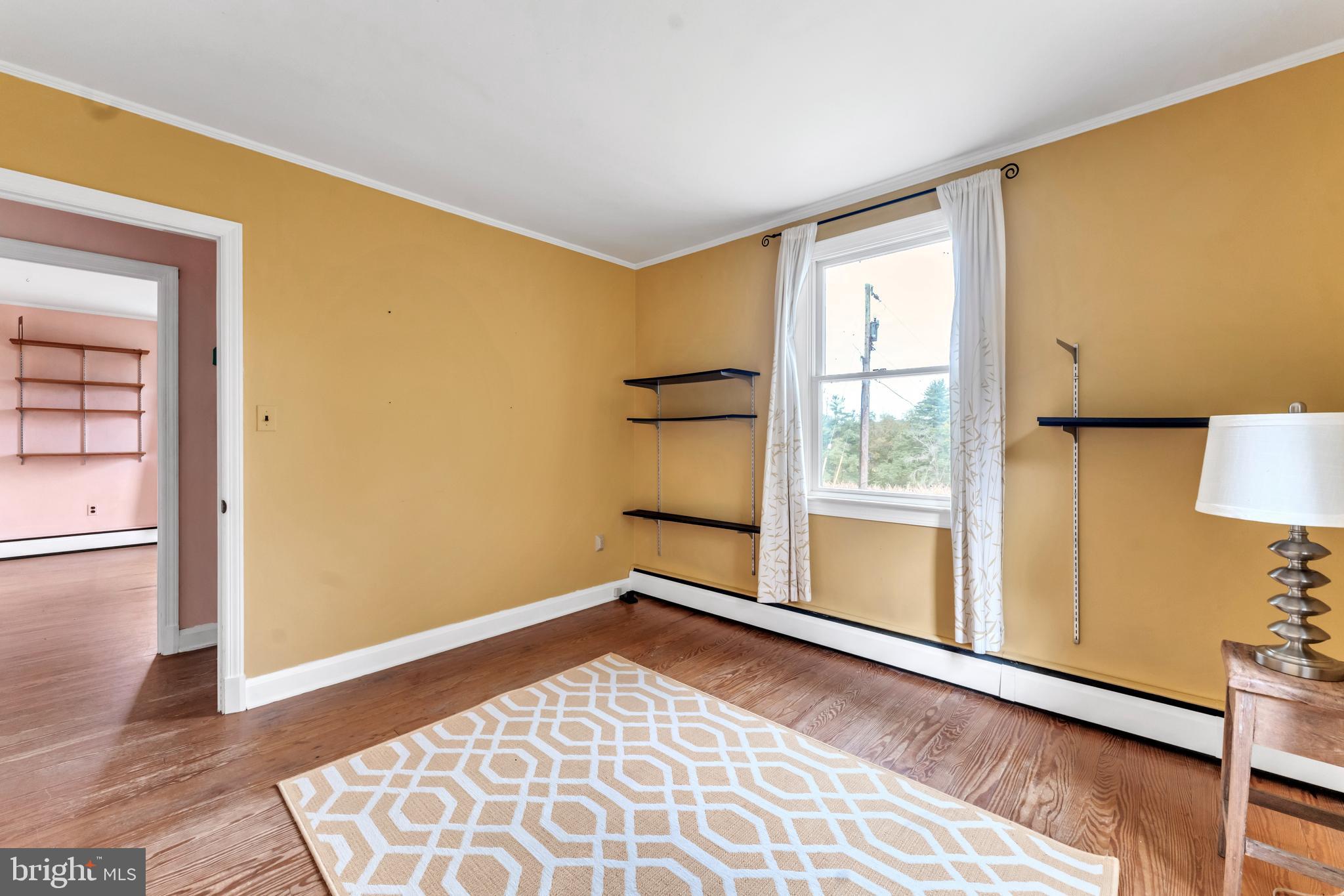18225 Gunpowder Road Hampstead, MD 21074 - Photo 9 of 30 wooden floor in an empty room with a window