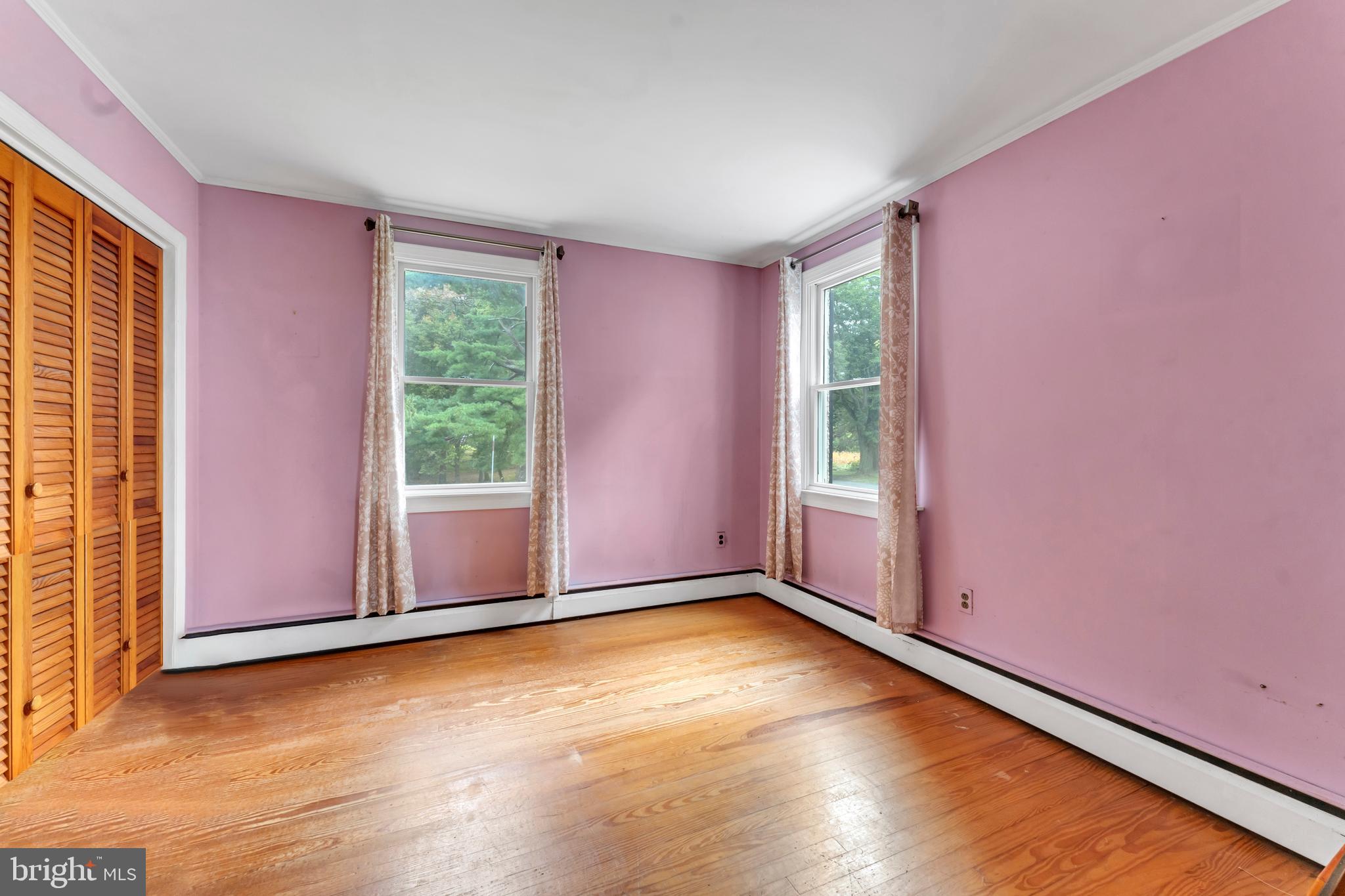 18225 Gunpowder Road Hampstead, MD 21074 - Photo 10 of 30 an empty room with wooden floor and windows