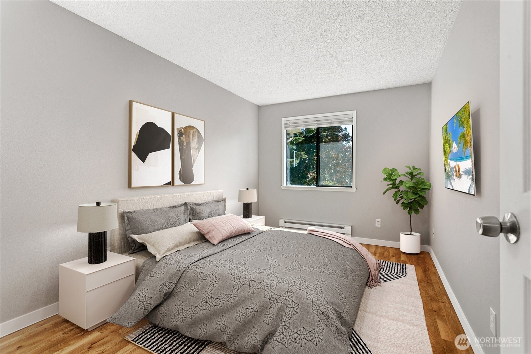 1802 Maple Lane, Unit A5 Kent, WA 98030 - Photo 16 of 27 a bedroom with a bed and wooden floor