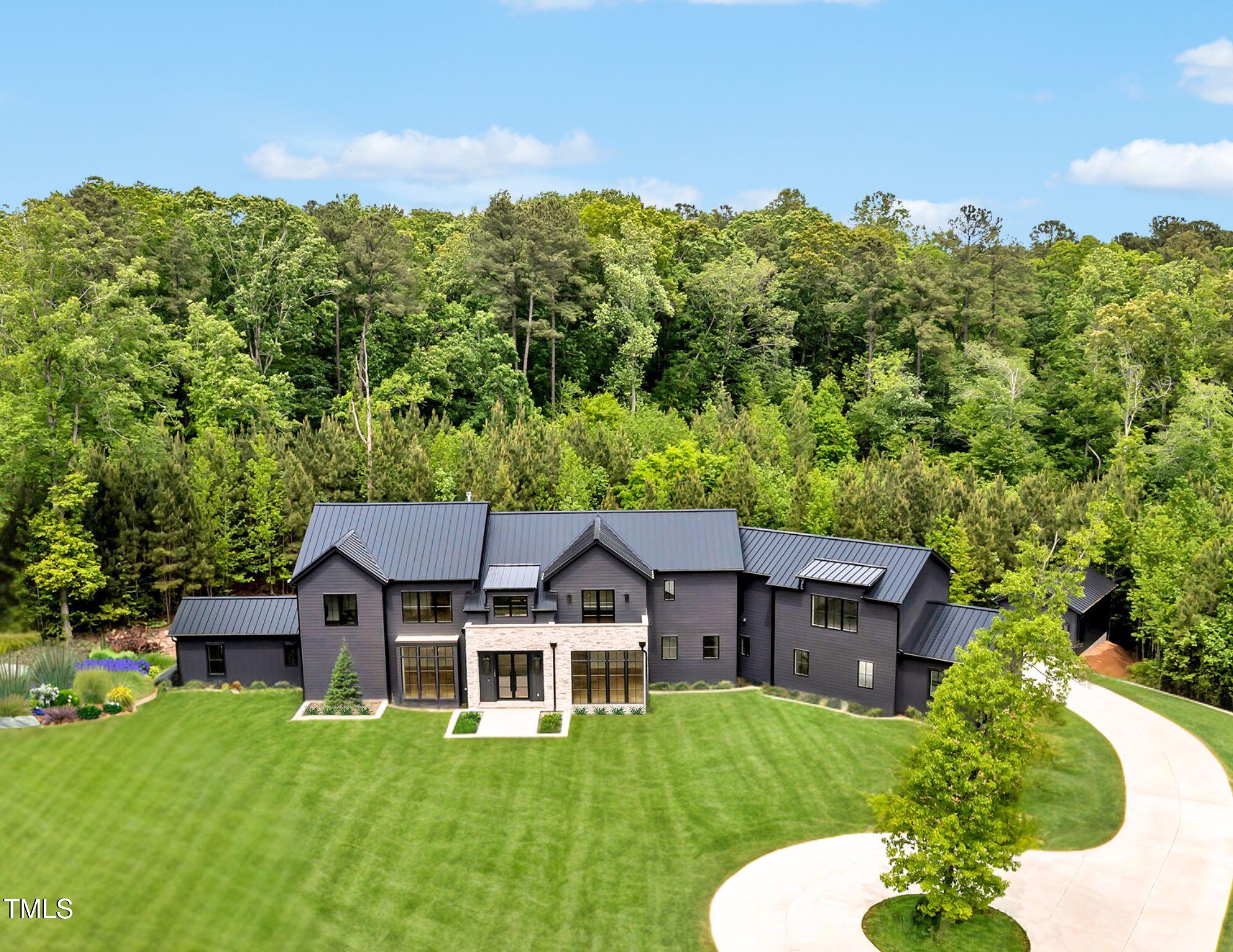 586 Poythress Road Chapel Hill, NC 27516 - Photo 19 of 33 a aerial view of a house with a big yard