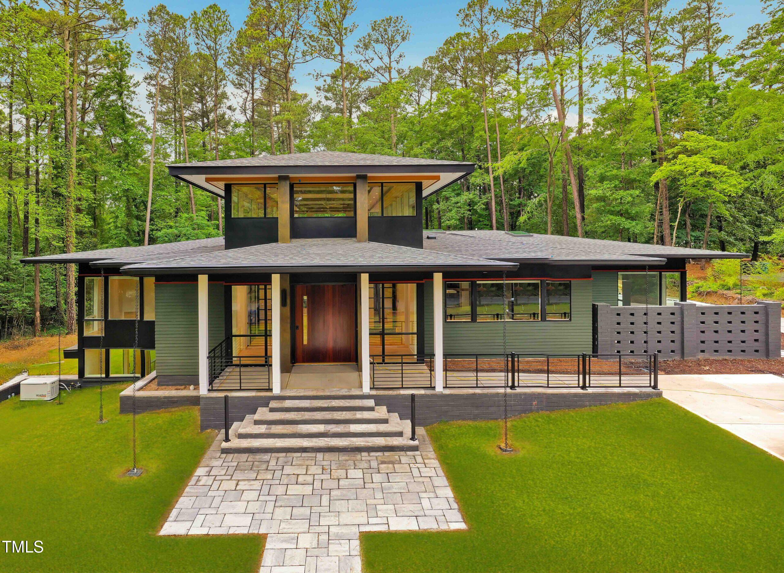 586 Poythress Road Chapel Hill, NC 27516 - Photo 20 of 33 a front view of a house with a yard porch and furniture