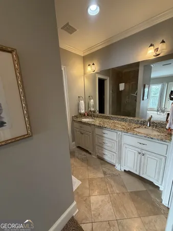 a bathroom with a granite countertop sink a mirror and a