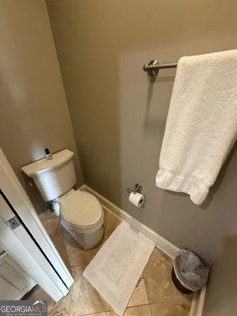 a white toilet sitting next to a bathroom sink and a tub