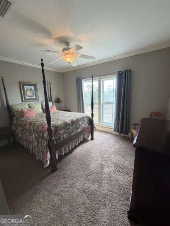 a bedroom with bed and window