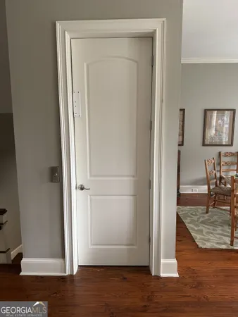 an empty room with wooden floor and dining room