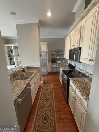a kitchen with granite countertop stainless steel appliances and wooden cabinets