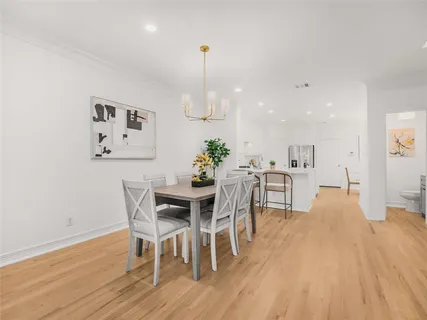 a view of a dining room with furniture and wooden floor