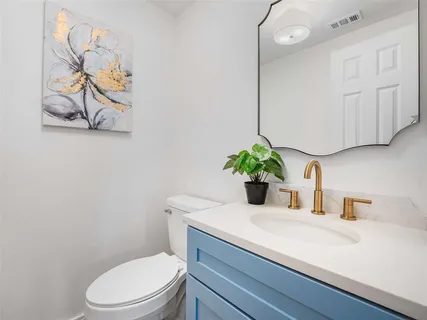 a bathroom with a sink a toilet and vanity