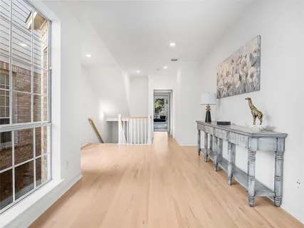 a view of a bedroom with wooden floor