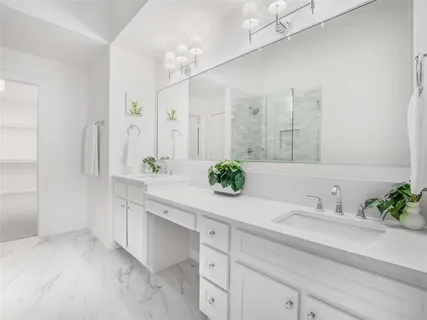 a bathroom with a sink double vanity and a mirror