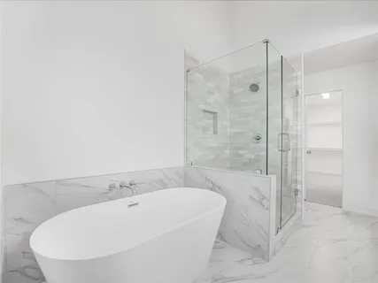 a bathroom with a tub and shower