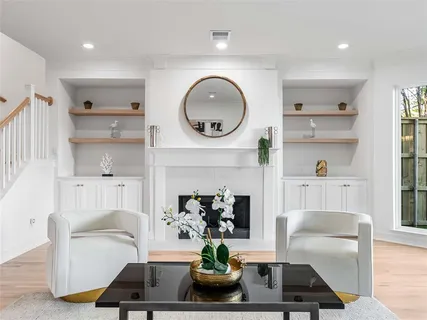a living room with furniture a mirror and a fireplace